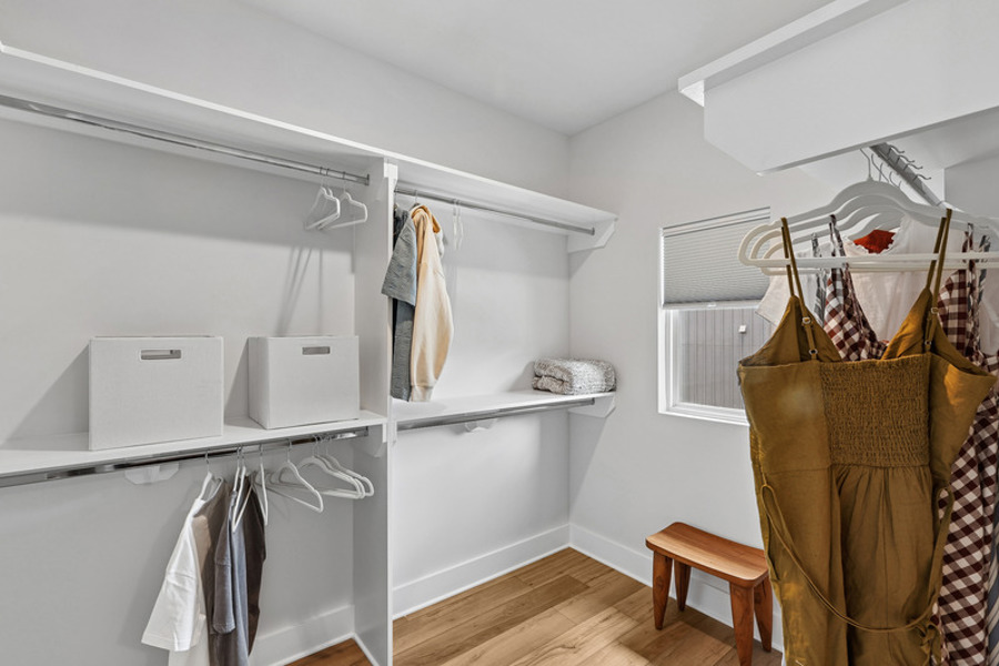 Walk-in closet with built-in shelving and ample storage space at HARMON West Meade in Nashville, Tennessee.